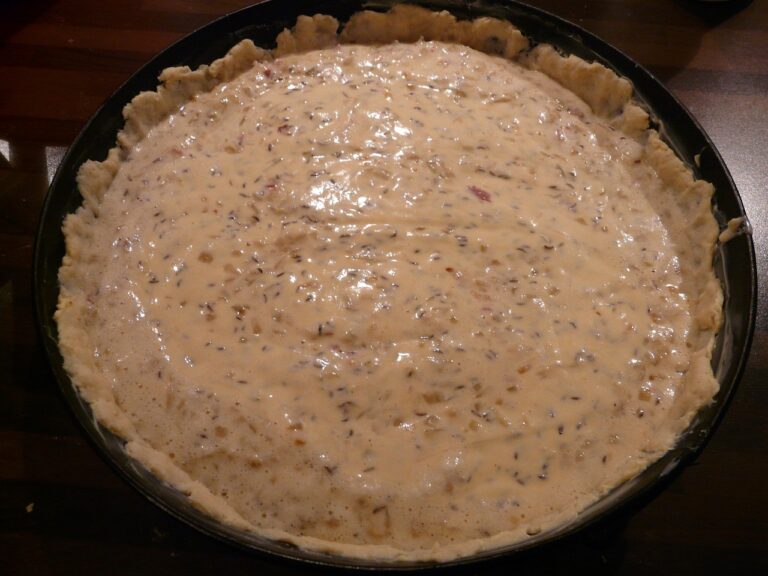 Torta salata con fondo molliccio, pasta bucherellata e cotta "in bianco" prima della farcitura.
